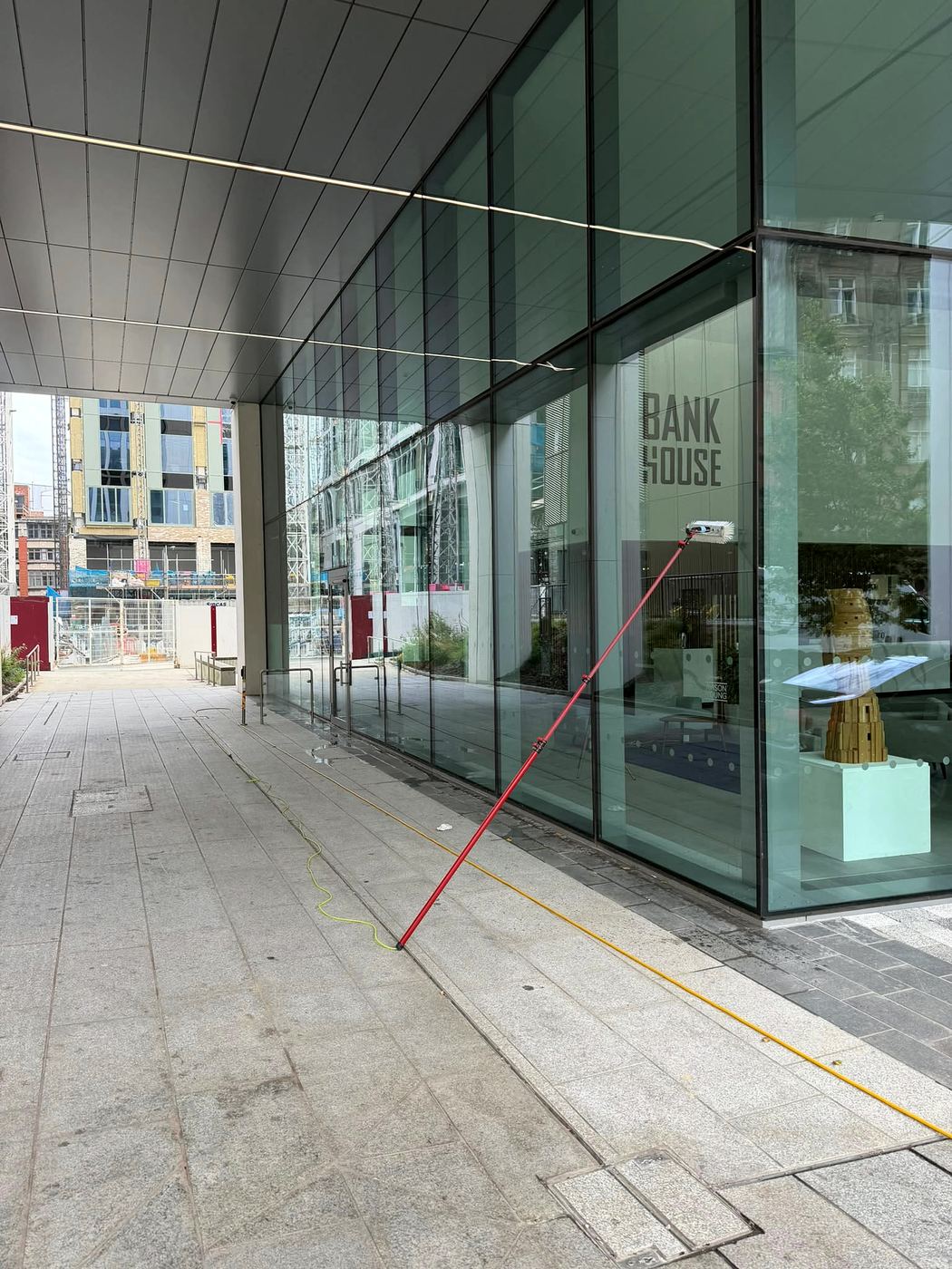 Water-fed pole cleaning the ground-floor glass at Bank House