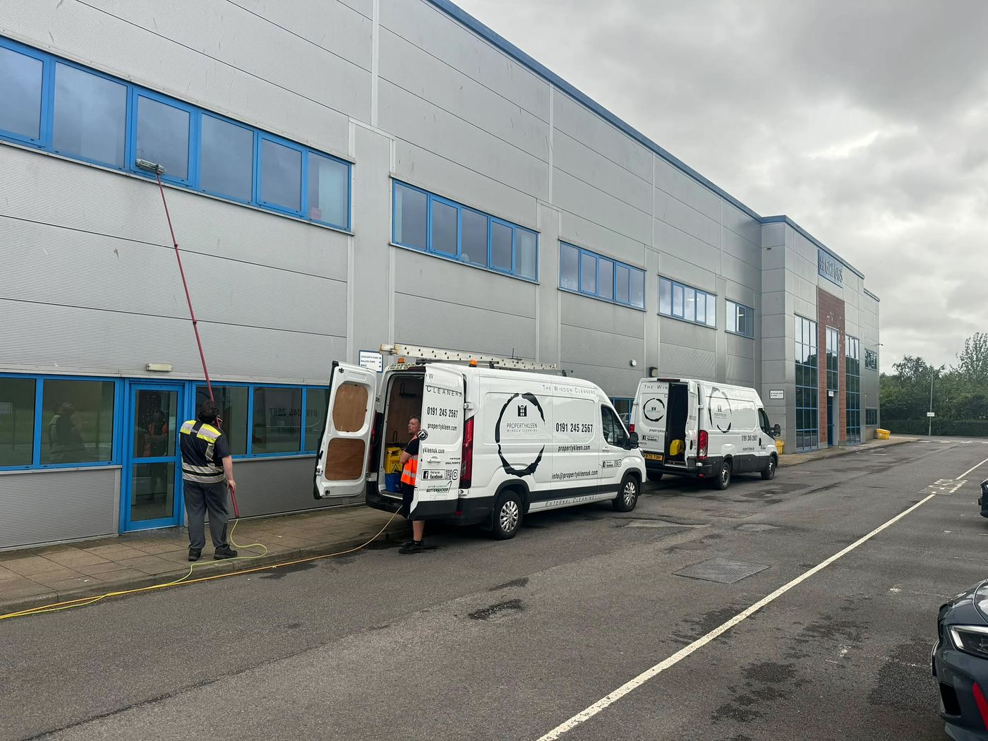 PropertyKleen vans and team cleaning windows at Greggs